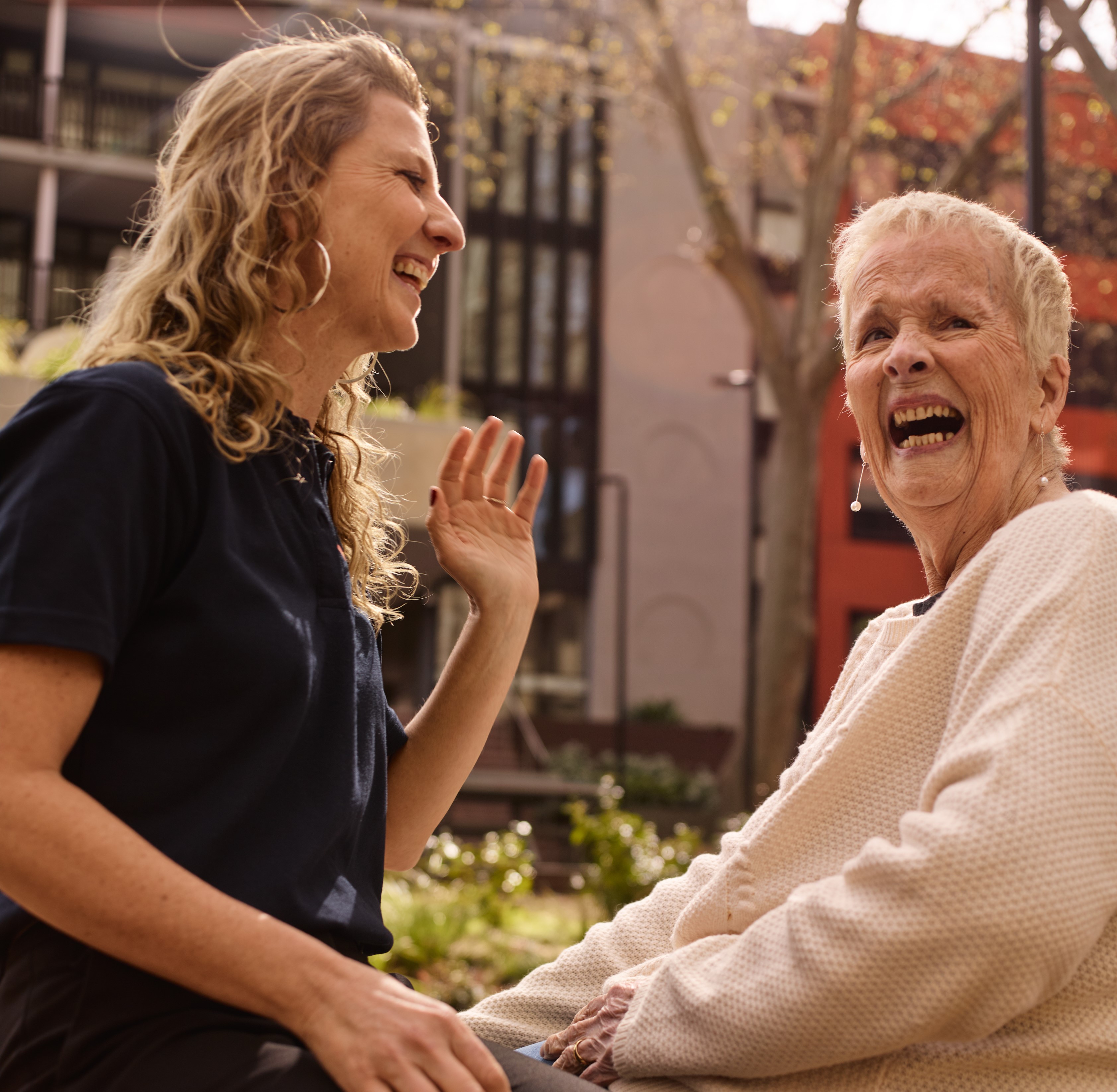 2 people sitting and laughing to each other